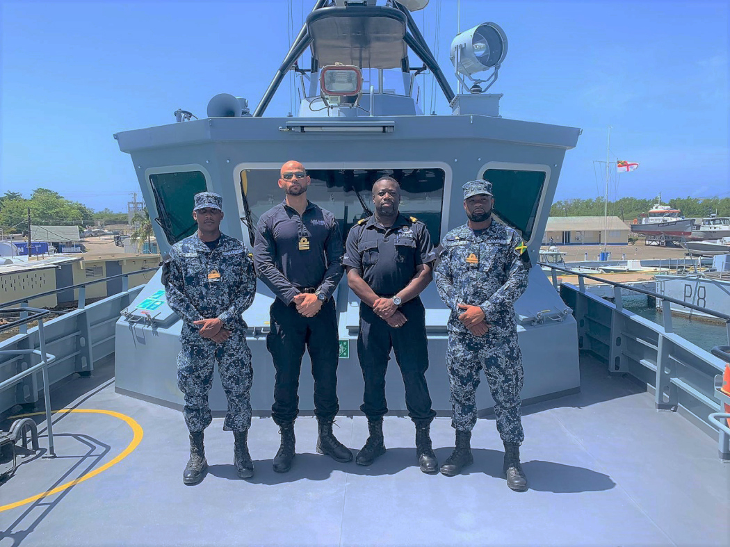 Lieutenant Commander Anglin and Police Constable Clarke with members of the Jamaica Defense Force