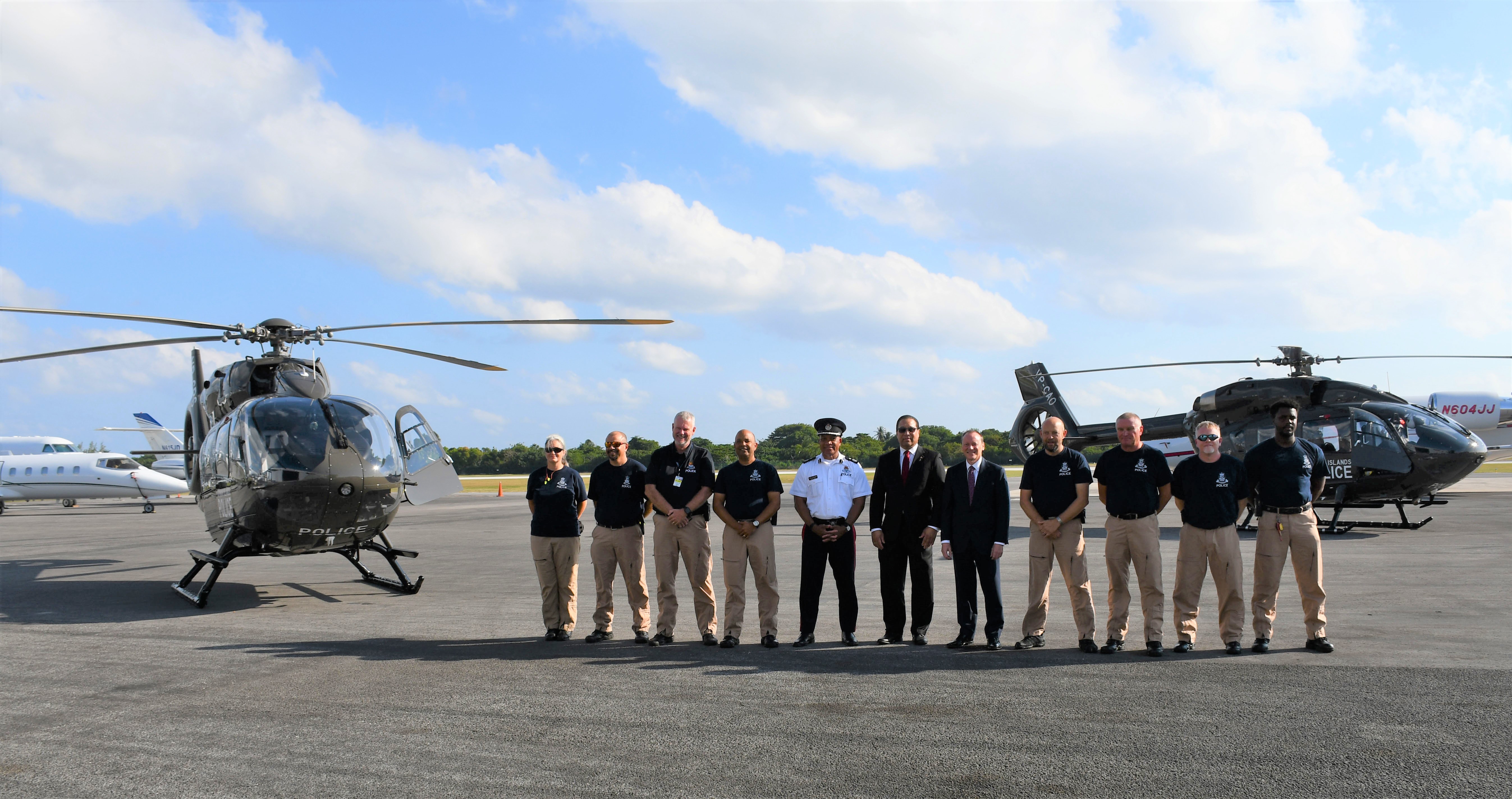 6. Governor, Premier and RCIPS Air Operations Unit with both helicopters